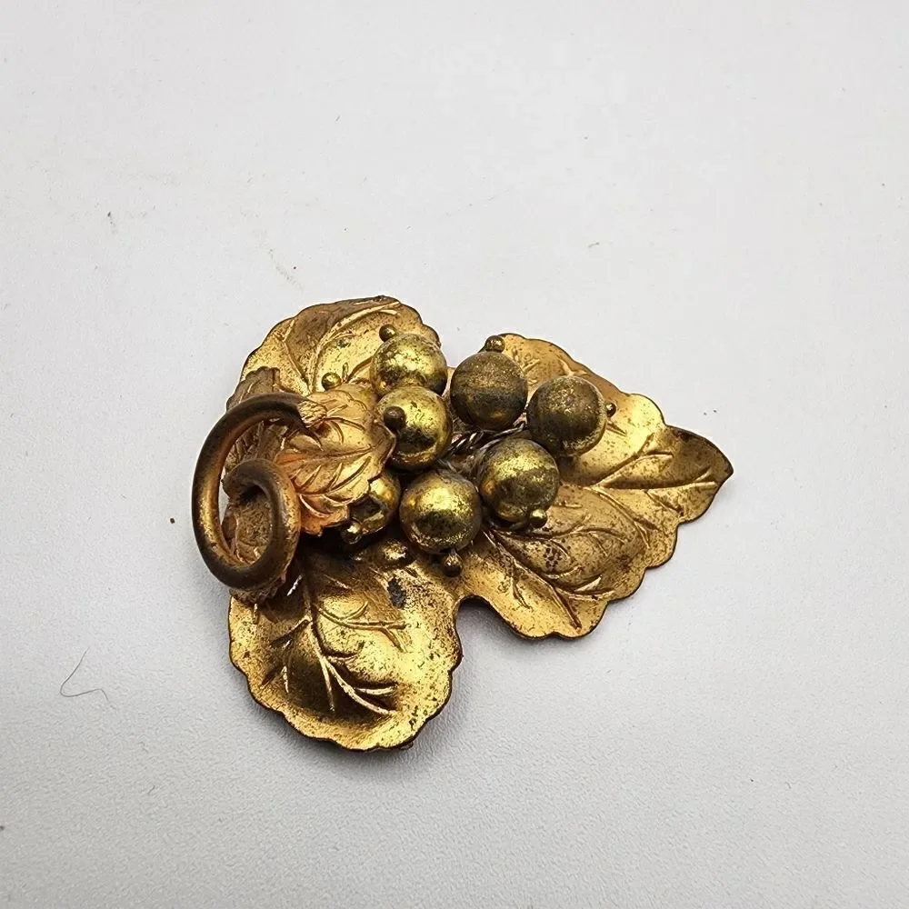 Vintage brass grapes brooch